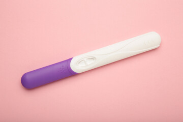 New pregnancy tests on pink background. Waiting negative or positive result. Top view
