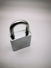 Fototapeta premium A close-up view of a silver padlock resting on a light background, symbolizing security and protection