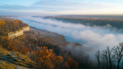 Foggy riverbank landscape with autumn foliage at dawn, showcasing serene natural beauty