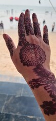 Henna hand with beach background 