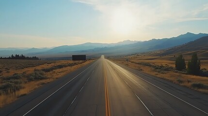 Fototapeta premium Billboard mockup on a highway with mountains in the distance, blank area for advertising