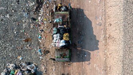 Aerial view garbage pile in landfill, Garbage pile in trash dump landfill, Truck waste dump and backho work waste household in waste landfill, Environment global warming.