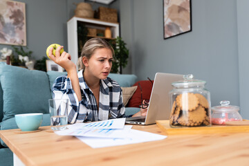 Smiling young woman working at home. Successful professional occupation female work on laptop...