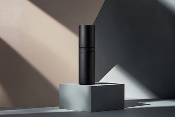 A sleek black container on a geometric pedestal, illuminated by dramatic lighting.