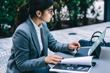 Businesswoman with tablet outside cafe