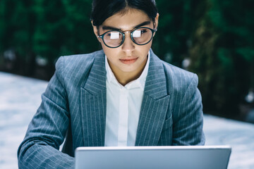 Young woman working attentively on tablet