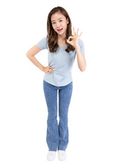 Fototapeta premium Young woman making an okay gesture, smiling, dressed casually, isolated on white background.