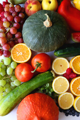 Various seasonal fruits and vegetables on white background. Summer and fall produce. Top view.