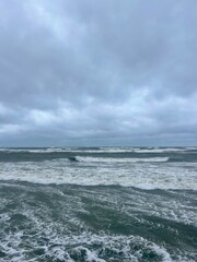 stormy cloudy seascape, waves at the sea, rainy clouds