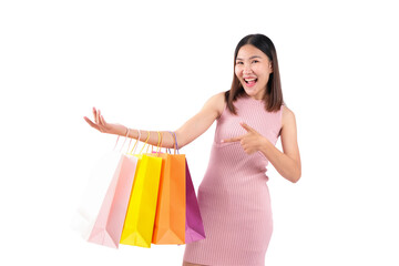 Young woman happily showcasing her shopping bags against a white background.