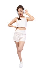 Young woman enjoying music with headphones, stylish casual outfit, joyful expression, white isolate background.