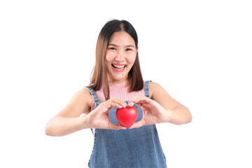 Cheerful woman holding a red heart, expressing love and happiness, on a white isolated background.