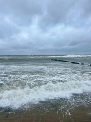 stormy cloudy seascape, waves at the sea, rainy clouds