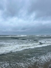stormy cloudy seascape, waves at the sea, rainy clouds