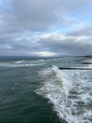 stormy cloudy seascape, waves at the sea, rainy clouds