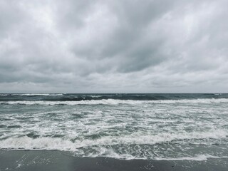 stormy cloudy seascape, waves at the sea, rainy clouds