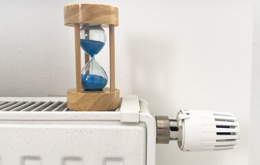 Hourglass over radiation sign on a light background