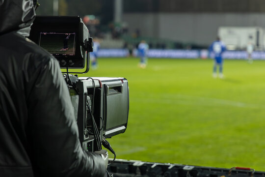 TV camera at the stadium, broadcasting during a football, soccer match