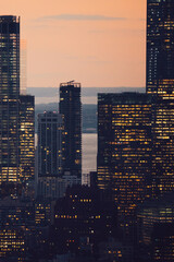 Aerial view of various high Manhattan skyscrapers buildings with lighted windows located in New...