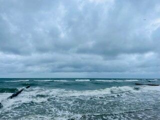 stormy cloudy seascape, waves at the sea, rainy clouds