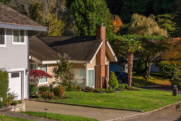 Luxury house with big tree and nice Fall foliage landscape in Vancouver, Canada, North America. Day...