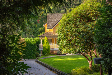 Luxury house with big tree and nice Fall foliage landscape in Vancouver, Canada, North America. Day...