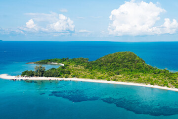 Fototapeta premium Aerial scenery view of picturesque island with crystal azure water and green vegetation.Bird's eye view of paradise beach shoreline, beautiful touristic destination for summer vacations,