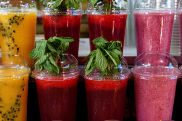 Colorful, refreshing and juicy fruit juice smoothie drinks for sale at a juice bar in the Carmel Market in Tel Aviv, Israel.