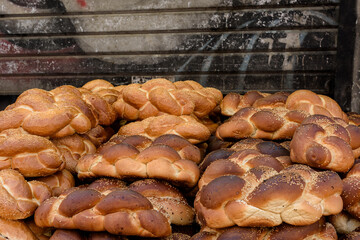Freshly baked, braided, seeded challah egg bread loaves on sale at a Jerusalem market ahead of the Jewish sabbath.