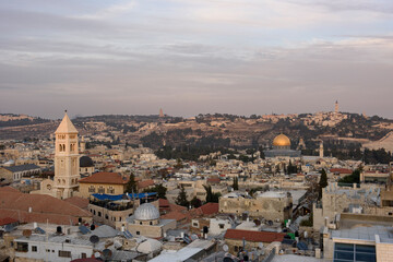 Fototapeta premium Aerial view of the Old City of Jerusalem with the Redeemer Lutheran Church, Dome of the Rock, and Mount Scopus in the distance.