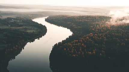 A serene river winding through a forested landscape during autumn.
