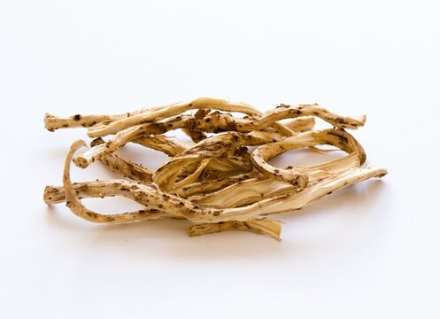 Dried roots of   Marsh mallow or marshmallow, lat. Althea officinalis on white. Traditional herb used  in herbalism against cough and as an ornamental plant.