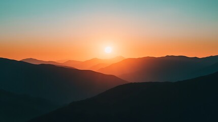 Fototapeta premium A vibrant sunset paints the sky over a silhouette of distant mountains.