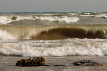 A large Lake Michigan wave explodes on-shore during a windy November day at Harrington Beach State...