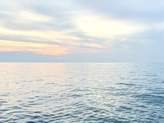 Obraz premium Calm sea under a sunset sky. waterline. sea water surface. mockup. product display. minimalistic. abstract background. horizontal