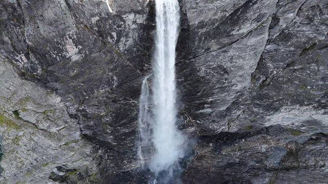 The drone zooms in and rises slowly behind mountains and Mardalsfossen in Eikesdal comes into view. The waterfall is one of the tallest waterfalls in Europe. A whopping 705 meters of waterfalls. 4K.