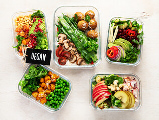 Glass containers with fresh vegan food, ready for meal prepping.