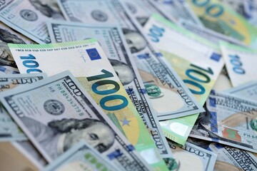 Obraz premium Big pile of Euro and USD banknotes. Many european and united states dollars