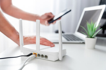Modern wi-fi router on light table in room
