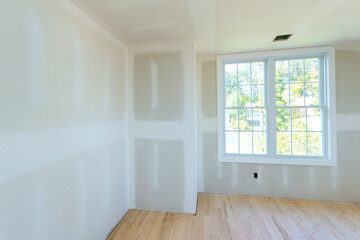 During construction, drywall is partially completed, but interior is unpainted drywall