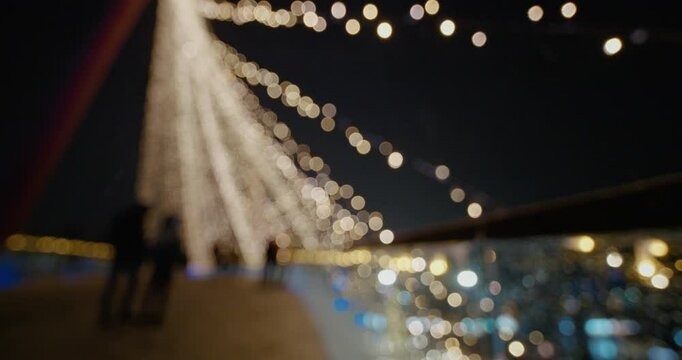 Holiday background with bridge in parck at the Christmas market. Out of focus holiday background. Light bokeh from Xmas tree. New Year theme, background.