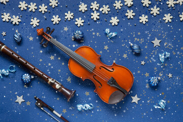 Old violin and flute with fir-tree branches with Christmas decor. Christmas and New Year's concept. Top view, close-up