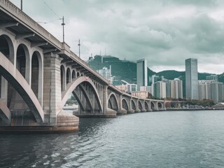 Fototapeta premium Majestic Stone Arch Bridge Over Calm Waters with Urban Skyline in Soft Focus - Perfect for Travel and Architecture Themes