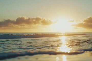 Obraz premium A serene sunset scene of the ocean on a sandy beach, great for travel or relaxation images