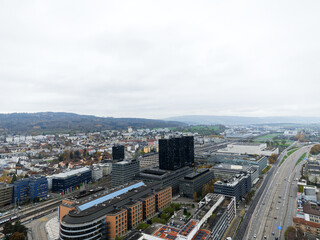 Obraz premium Aerial view over Swiss City of Zürich with cityscape at District of Altstetten on a cloudy autumn afternoon. Photo taken November 11th, 2024, Zurich, Switzerland.