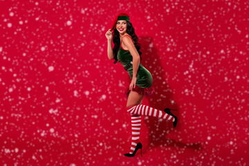 Photo of stunning lady stripper wear elf hat costume pantyhose high-heels isolated red color...