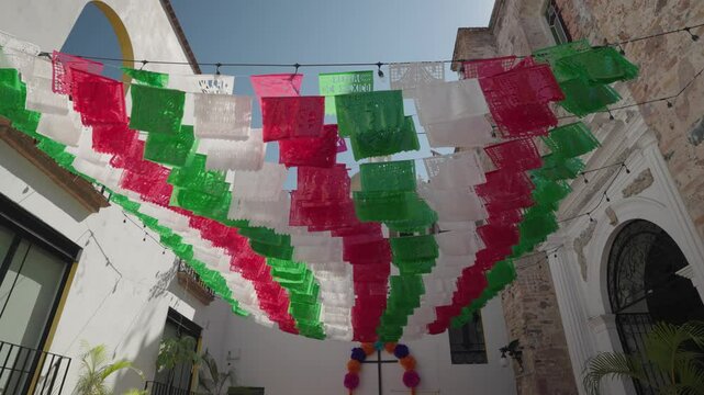 Mexican Papel Picado flags decorate Puerto Vallarta Malec&oacute;n and Church of Our Lady of Guadalupe in the Mexican state of Jalisco during Day of the Dead D&iacute;a de Muertos
