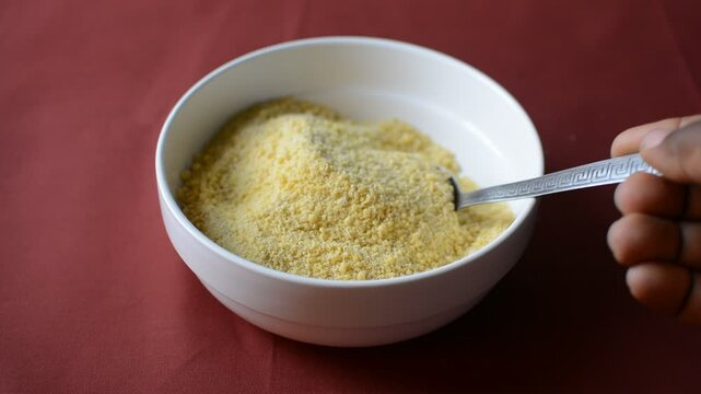Yellow garri in a white bowl, top view of nigerian garri in a ceramic bowl, fried cassava, garri for eba