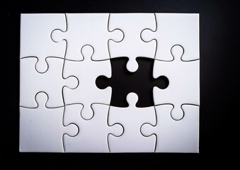 white puzzles arranged on a black background