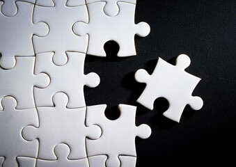 white puzzles arranged on a black background